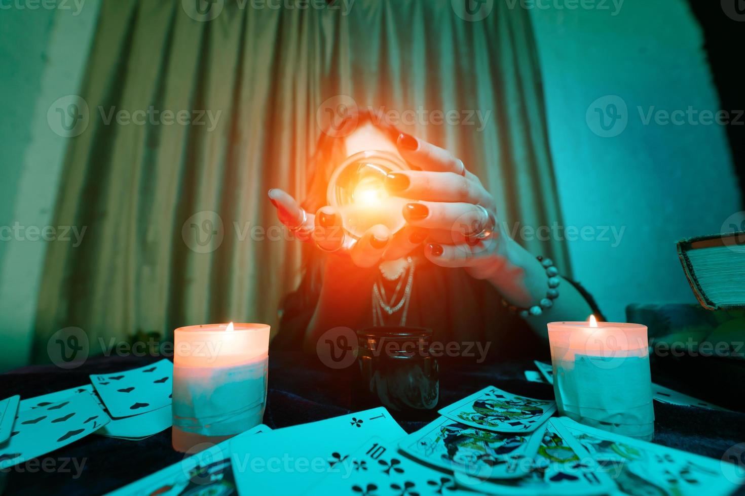 mulher vidente adivinha o destino da noite na mesa com velas foto