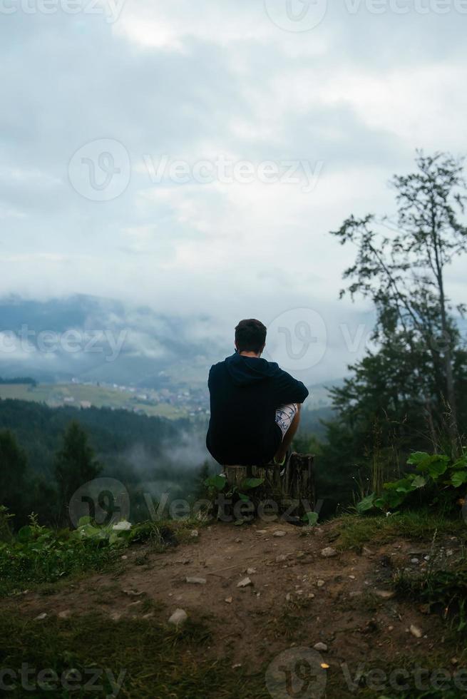 cara no topo de uma colina apreciando a vista da natureza foto