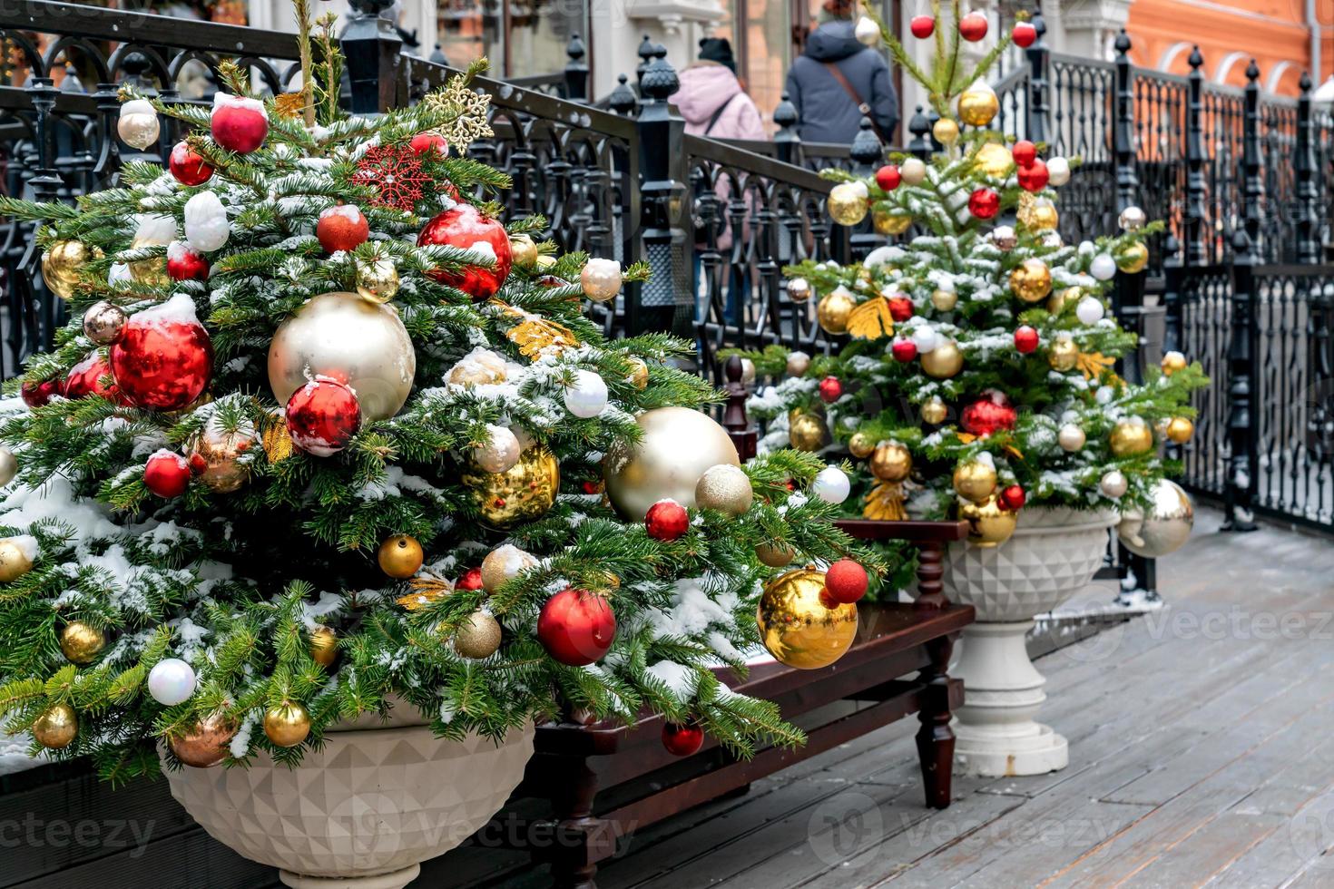 close-up de decoração de árvores de natal com brinquedos e guirlandas. decoração festiva da cidade durante as férias de inverno foto