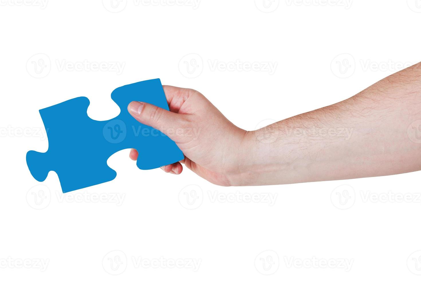 mão masculina com peça de quebra-cabeça azul foto