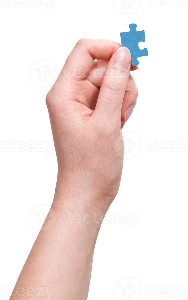 mão feminina com peça de quebra-cabeça foto