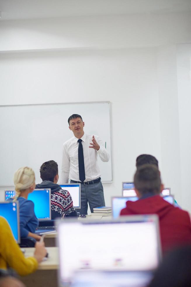 alunos com professor em sala de aula de laboratório de informática foto