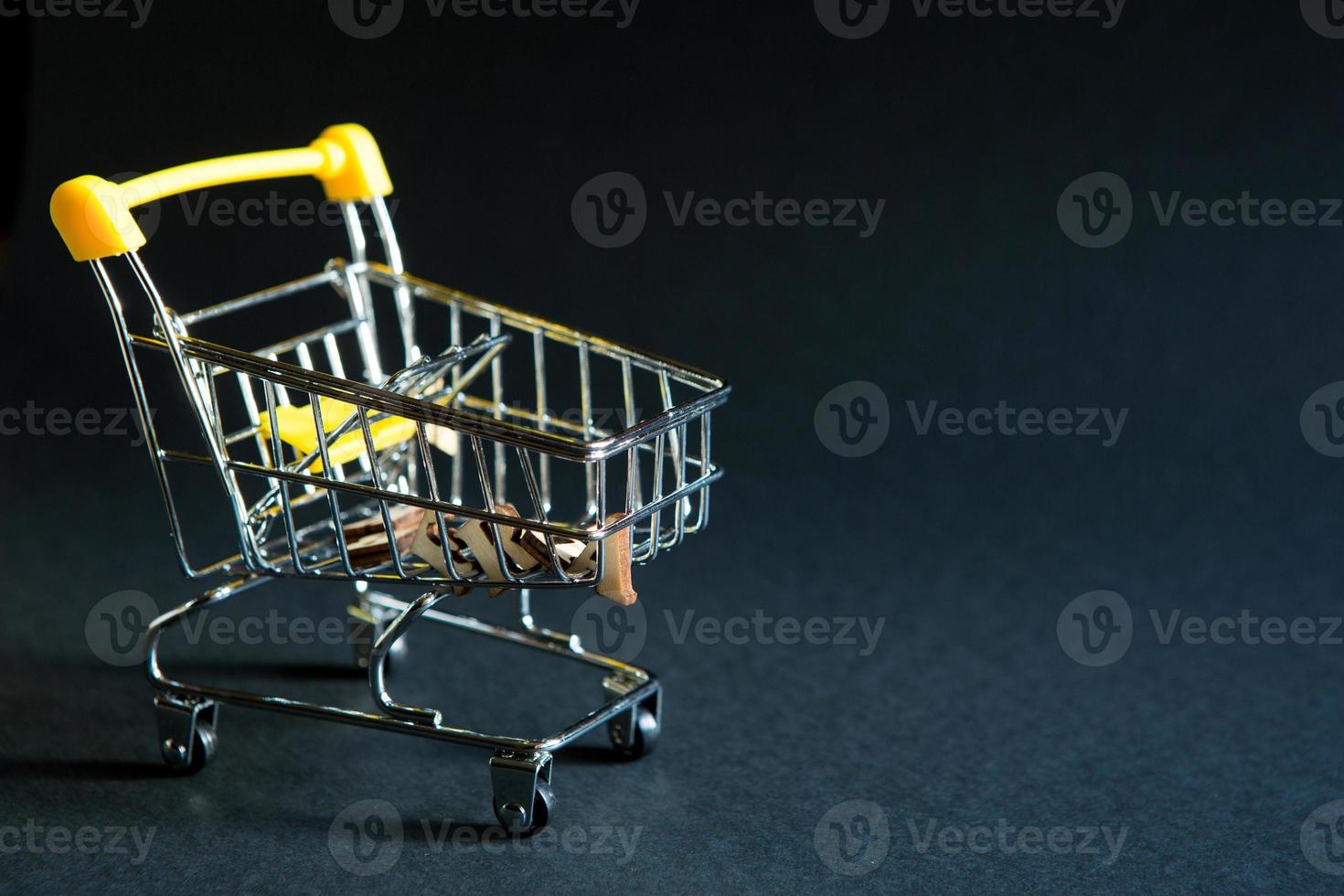 carrinho de supermercado vazio de um supermercado em um fundo preto. sexta-feira negra, carrinho de compras, compras, loja online, venda, descontos. espaço para texto foto