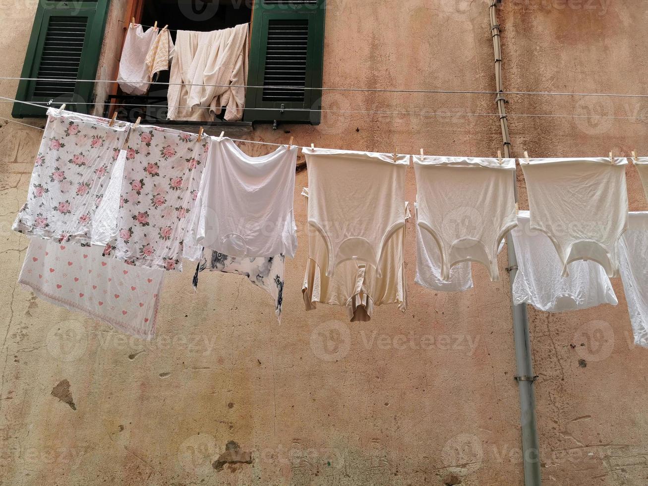 roupas penduradas para secar na vila pitoresca italiana foto