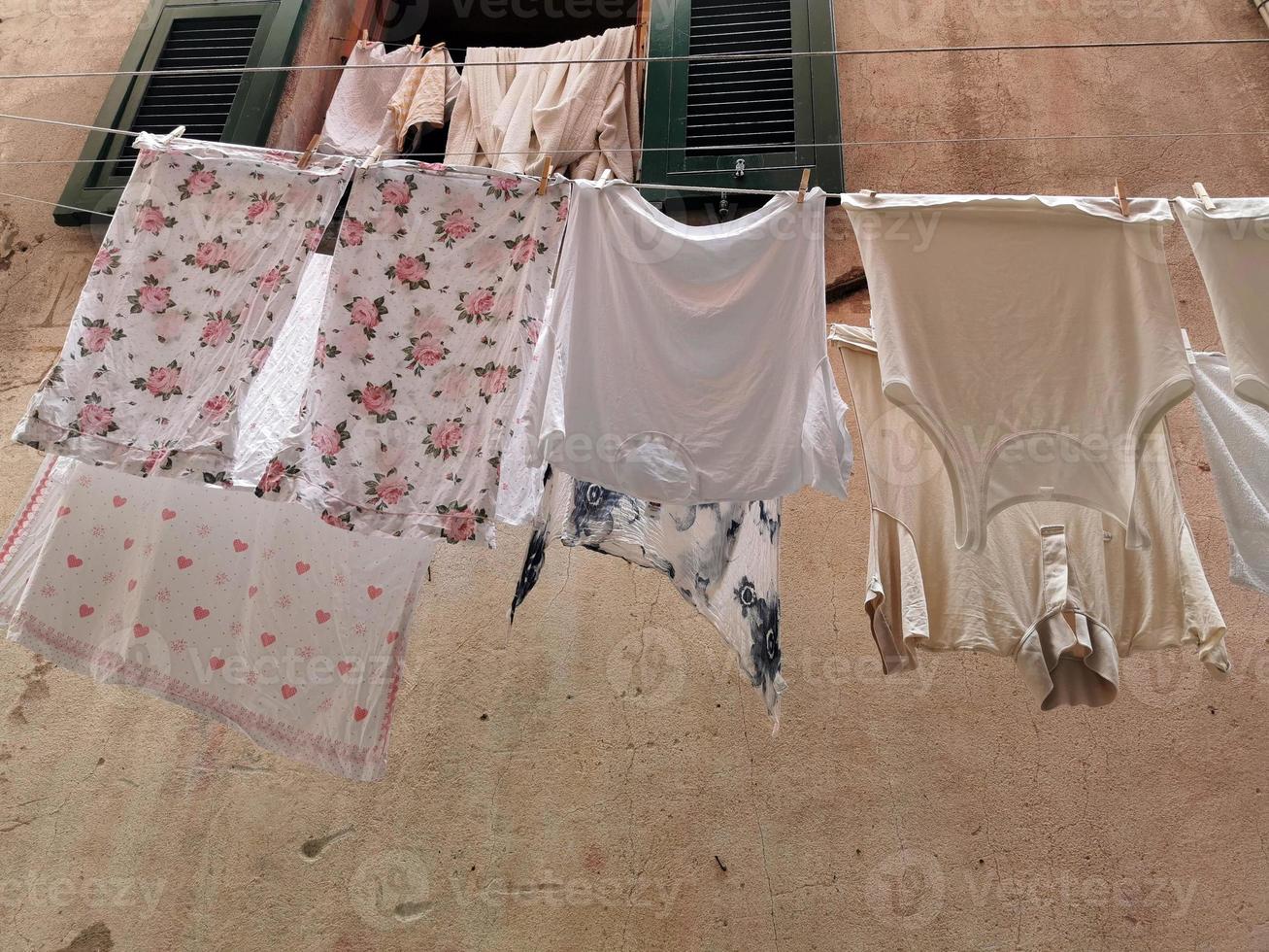 roupas penduradas para secar na vila pitoresca italiana foto