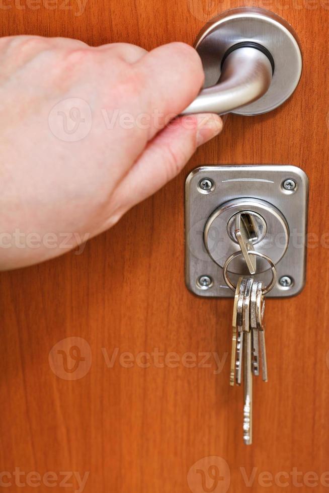 abrindo a porta de casa e molho de chaves foto