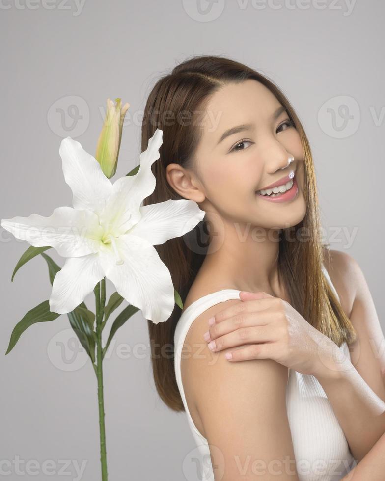retrato de uma linda mulher asiática sobre estúdio de fundo branco, cuidados com a pele e conceito de beleza foto