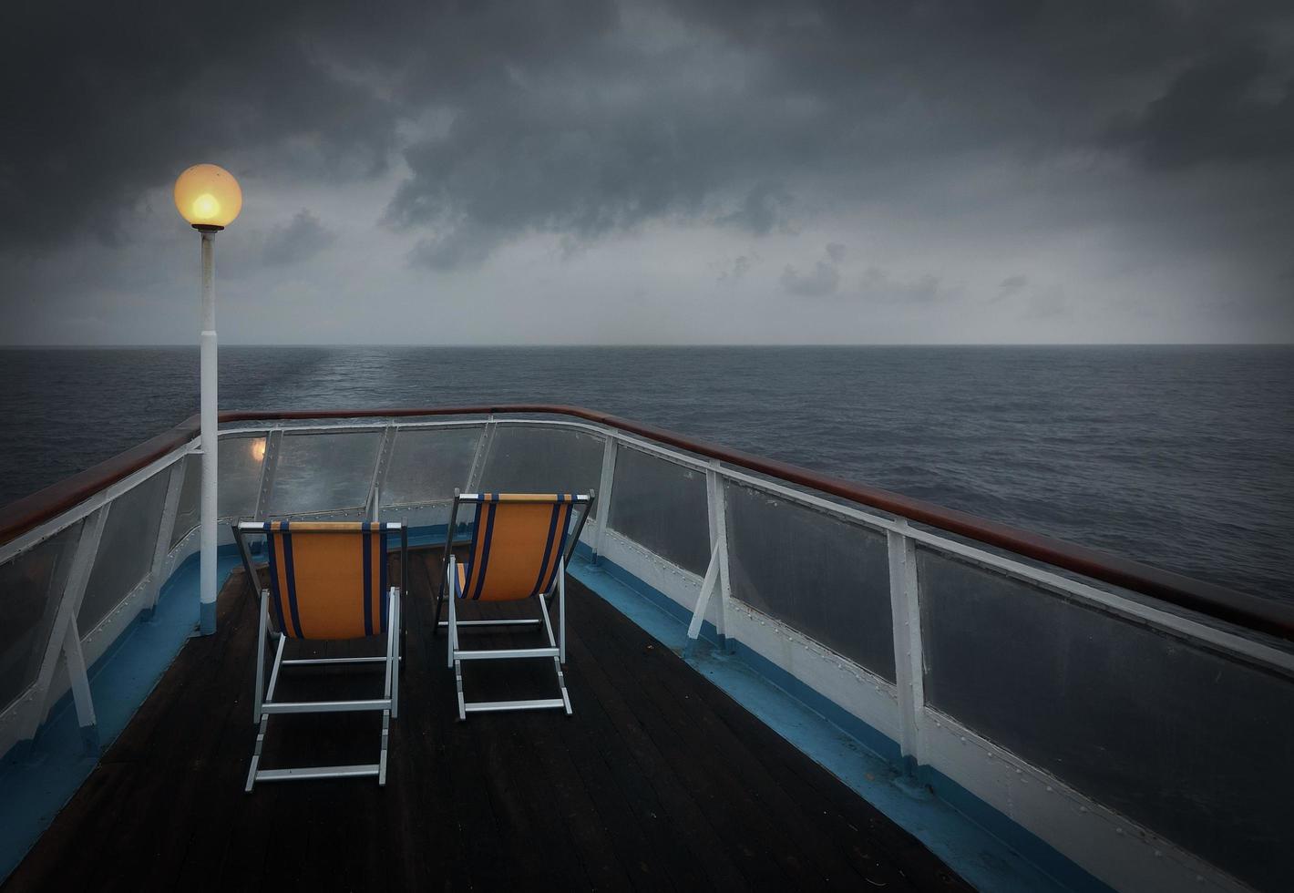 duas cadeiras dobráveis em um barco no mar foto