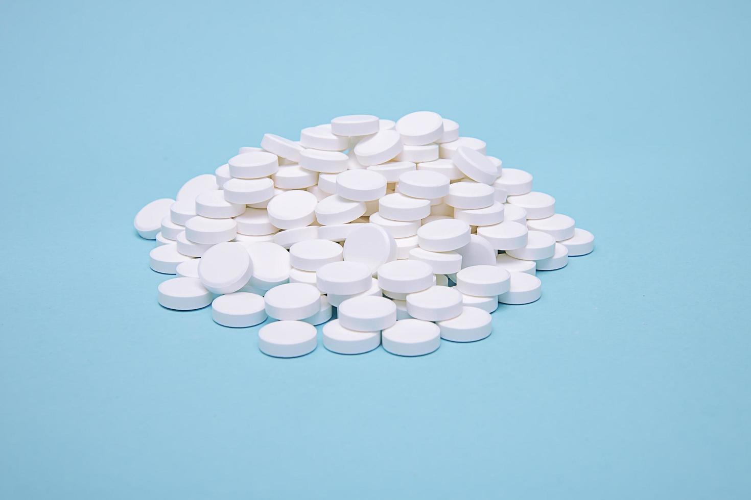 muitas pílulas dispostas em um slide em um fundo azul foto