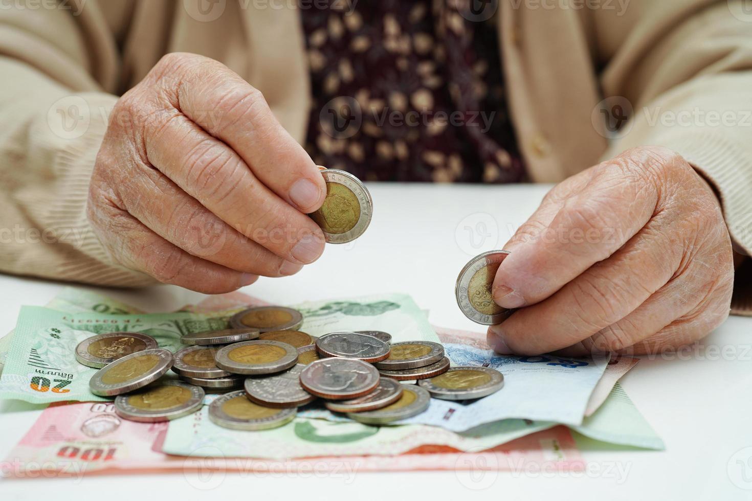 idosa aposentada contando dinheiro de moedas e se preocupa com despesas mensais e pagamento de taxa de tratamento. foto