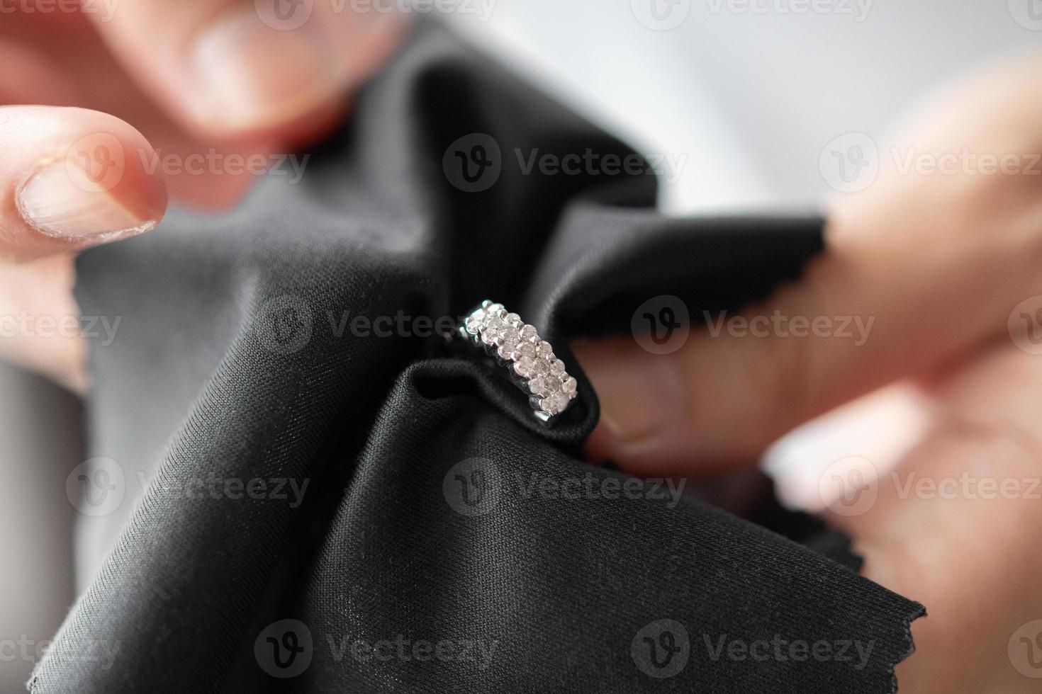 joalheiro limpeza brincos de diamante com pano de tecido foto