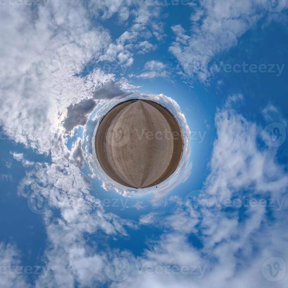 pequeno planeta no céu azul com belas nuvens com transformação do panorama esférico 360 graus. vista aérea abstrata esférica. curvatura do espaço. foto