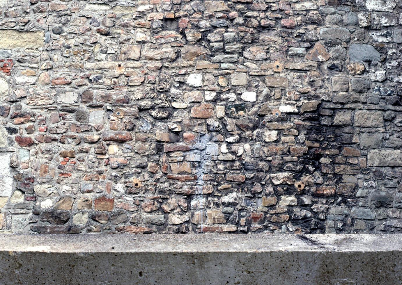 textura de parede de alvenaria escura. pedras marrons e rochas de forma diferente, textura abstrata e estilo vintage de fundo para o seu design de decoração foto