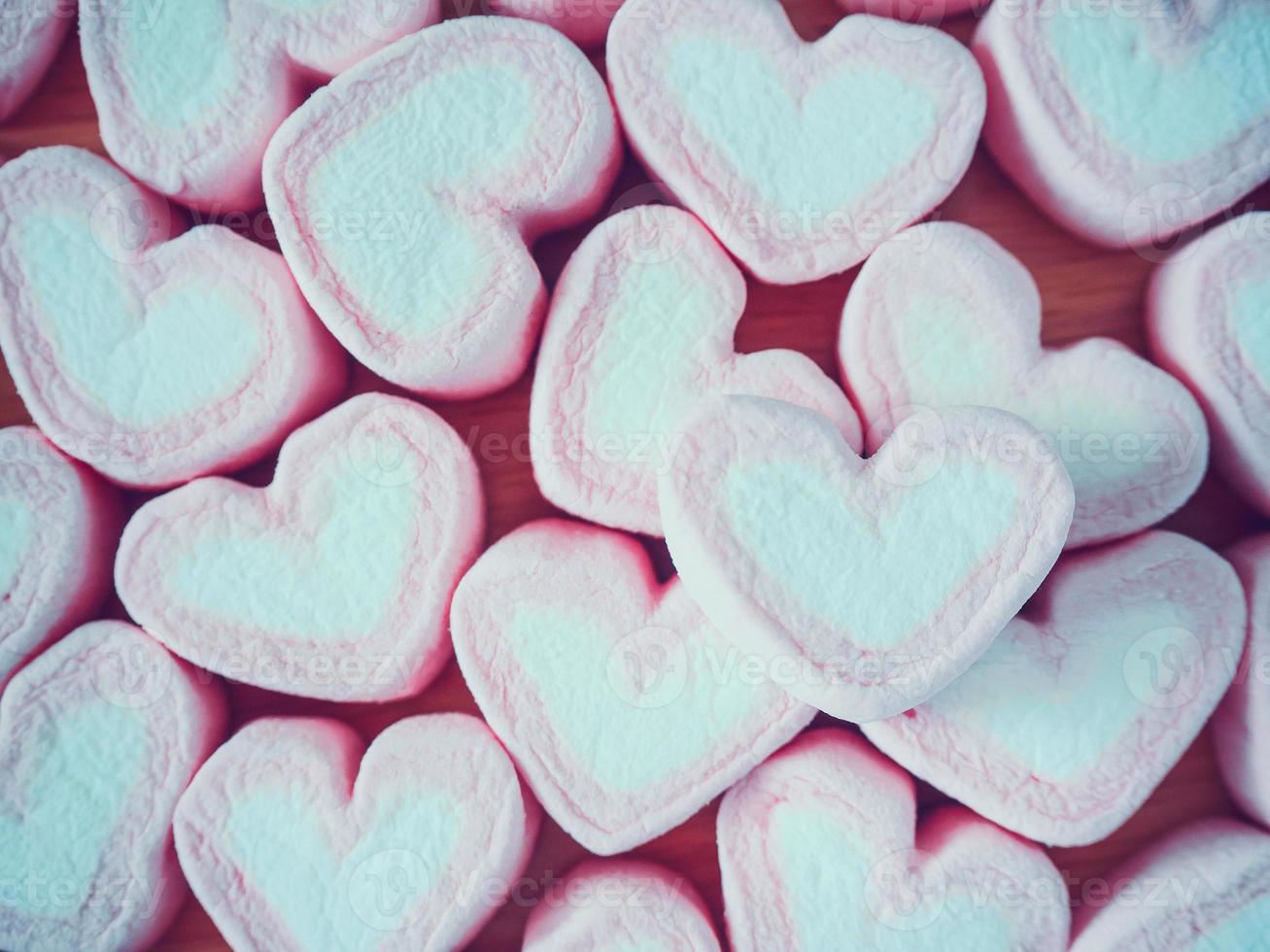 marshmallow de forma de coração rosa para fundo de dia dos namorados foto