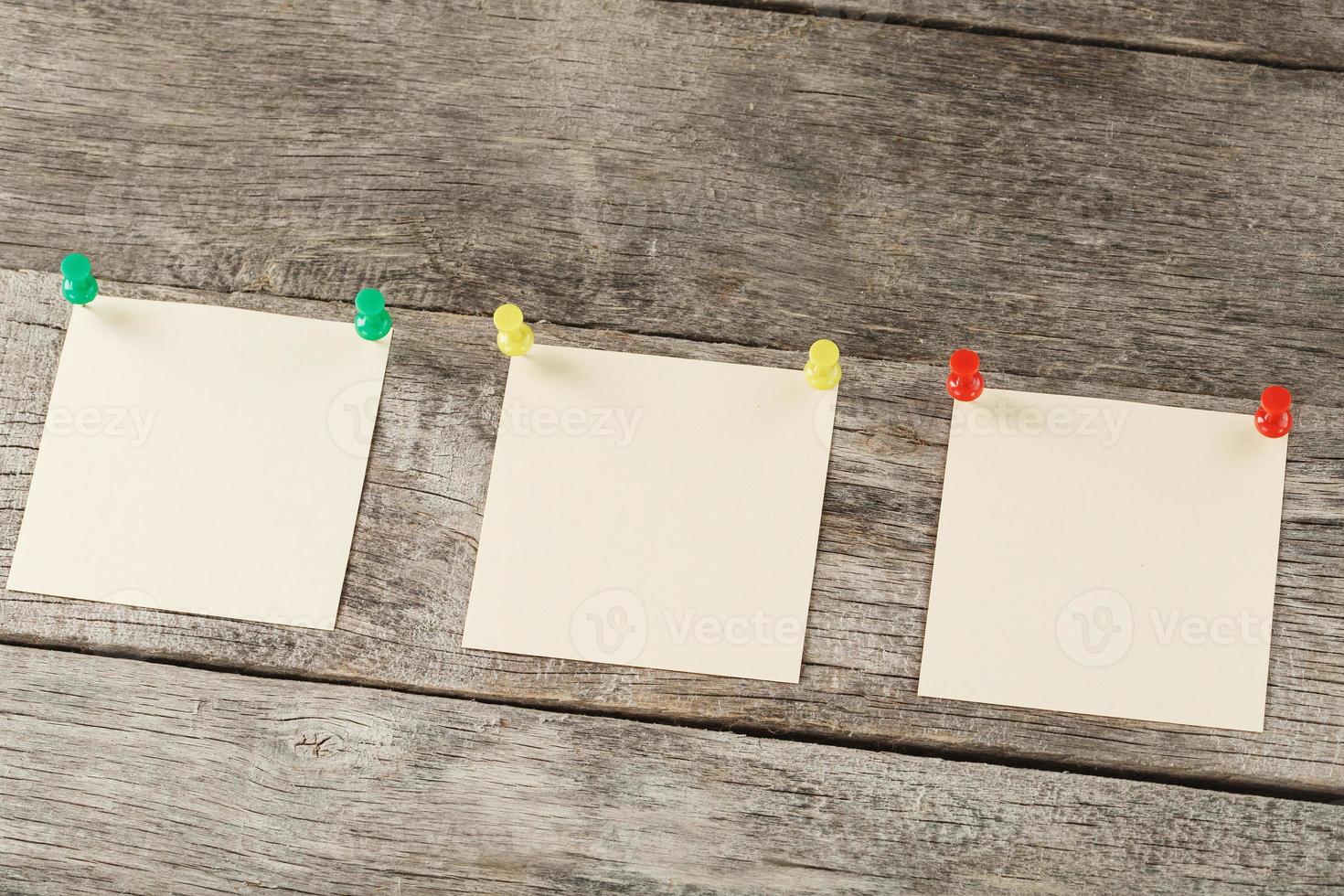 adesivos quadrados fixados em uma linha em uma mesa de madeira. foto