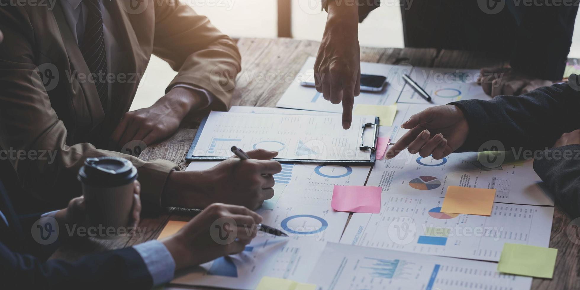 suporte de equipe de negócios e conceito de reunião. grupo de investidores trabalhando e apontando para a tarefa de finanças de papelada financeira. foto