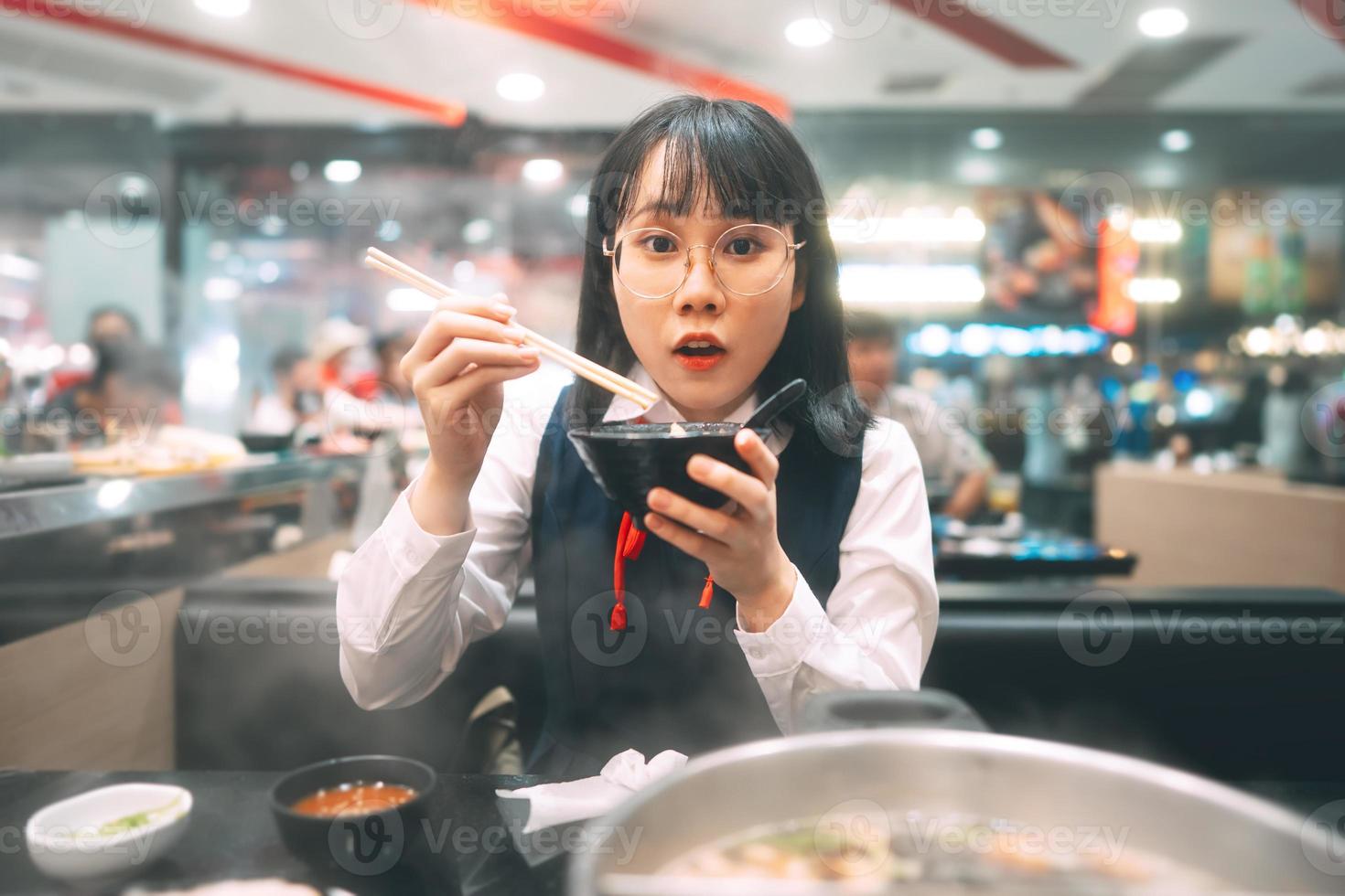 feliz jovem asiática estudante tailandês japonês comendo restaurante shabu japão sukiyaki. foto