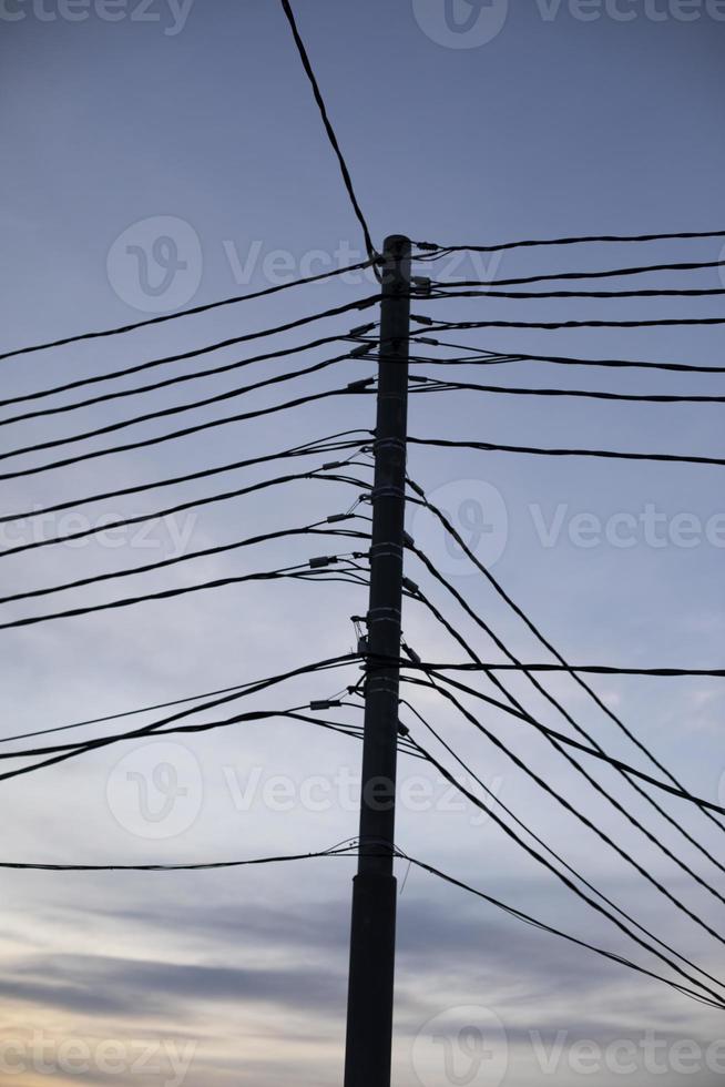 fios elétricos no poste. muitos fios contra o céu. foto