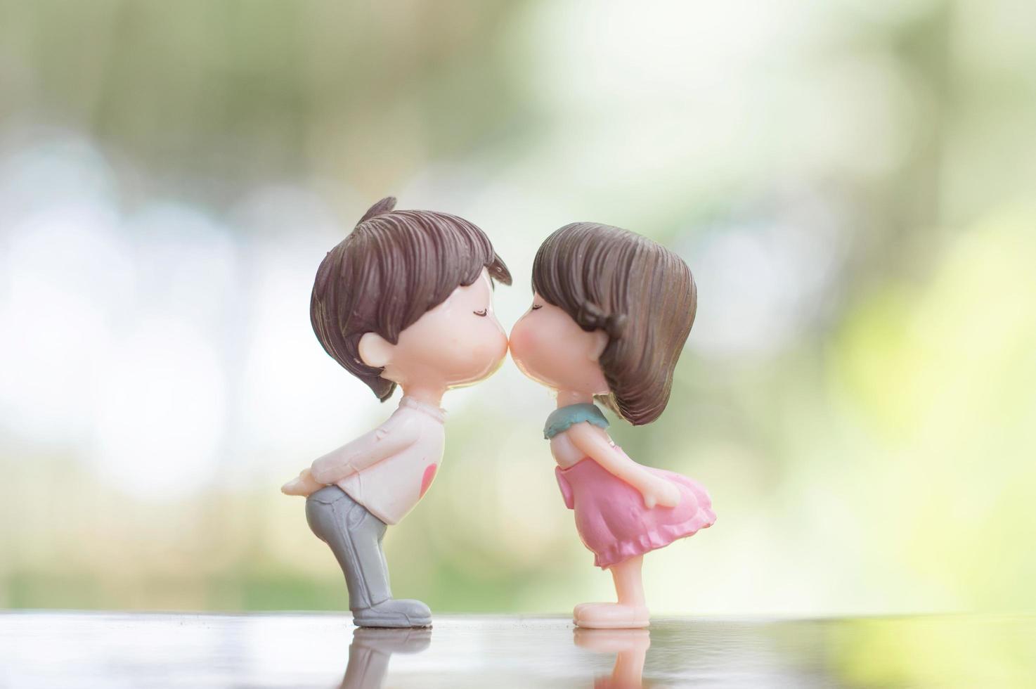 close-up de bonecos de mini casal em beijo romântico para o conceito de dia dos namorados foto