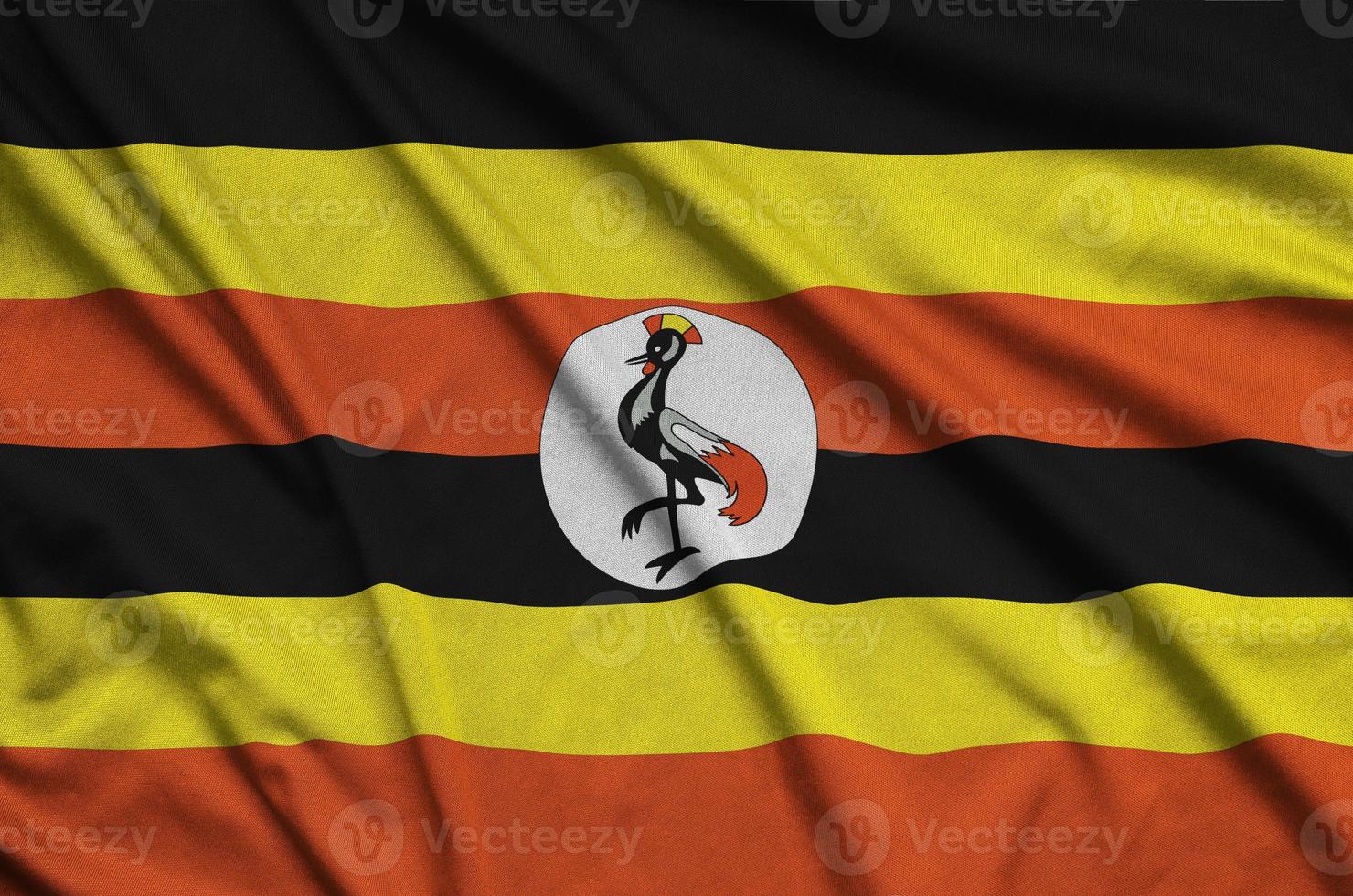 a bandeira de uganda é retratada em um tecido esportivo com muitas dobras. bandeira da equipe esportiva foto