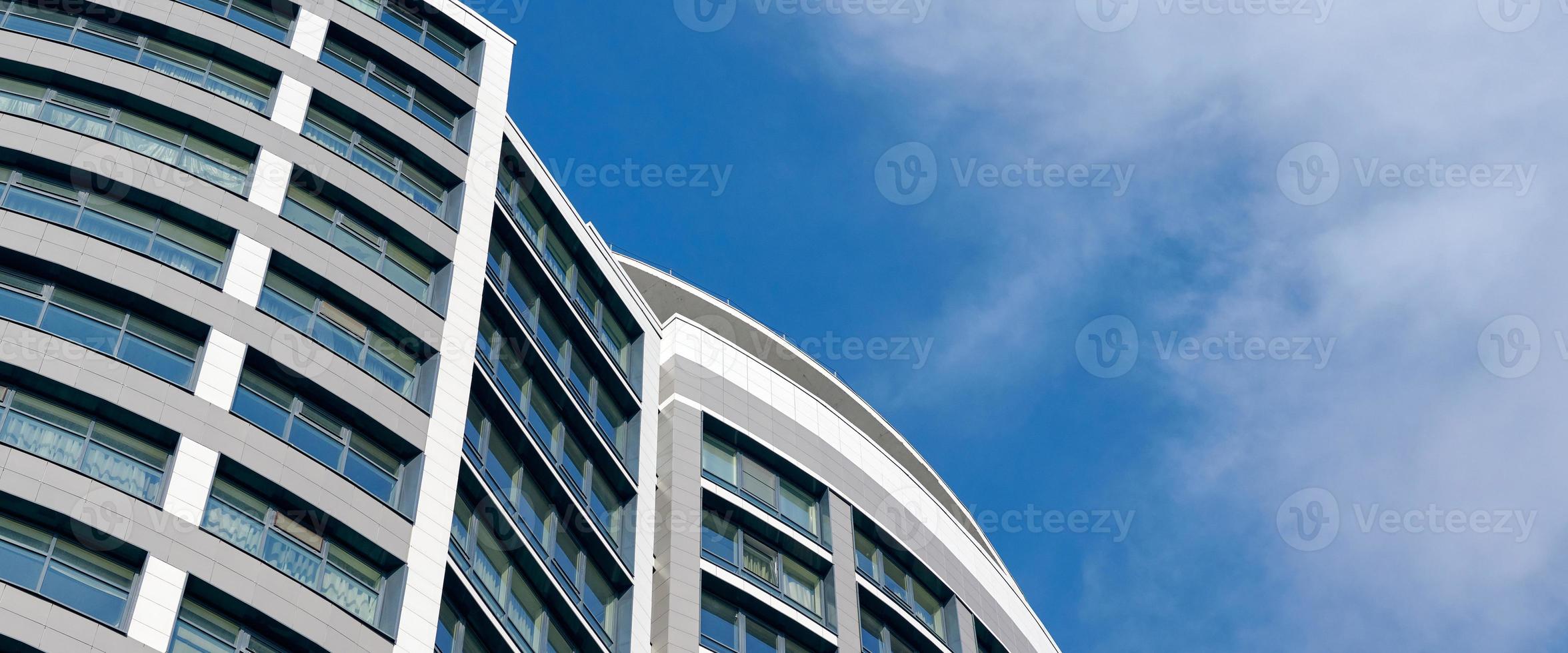 edifício de alto negócio de arranha-céu de escritório no fundo do céu azul, olhando para o edifício moderno de vidro foto