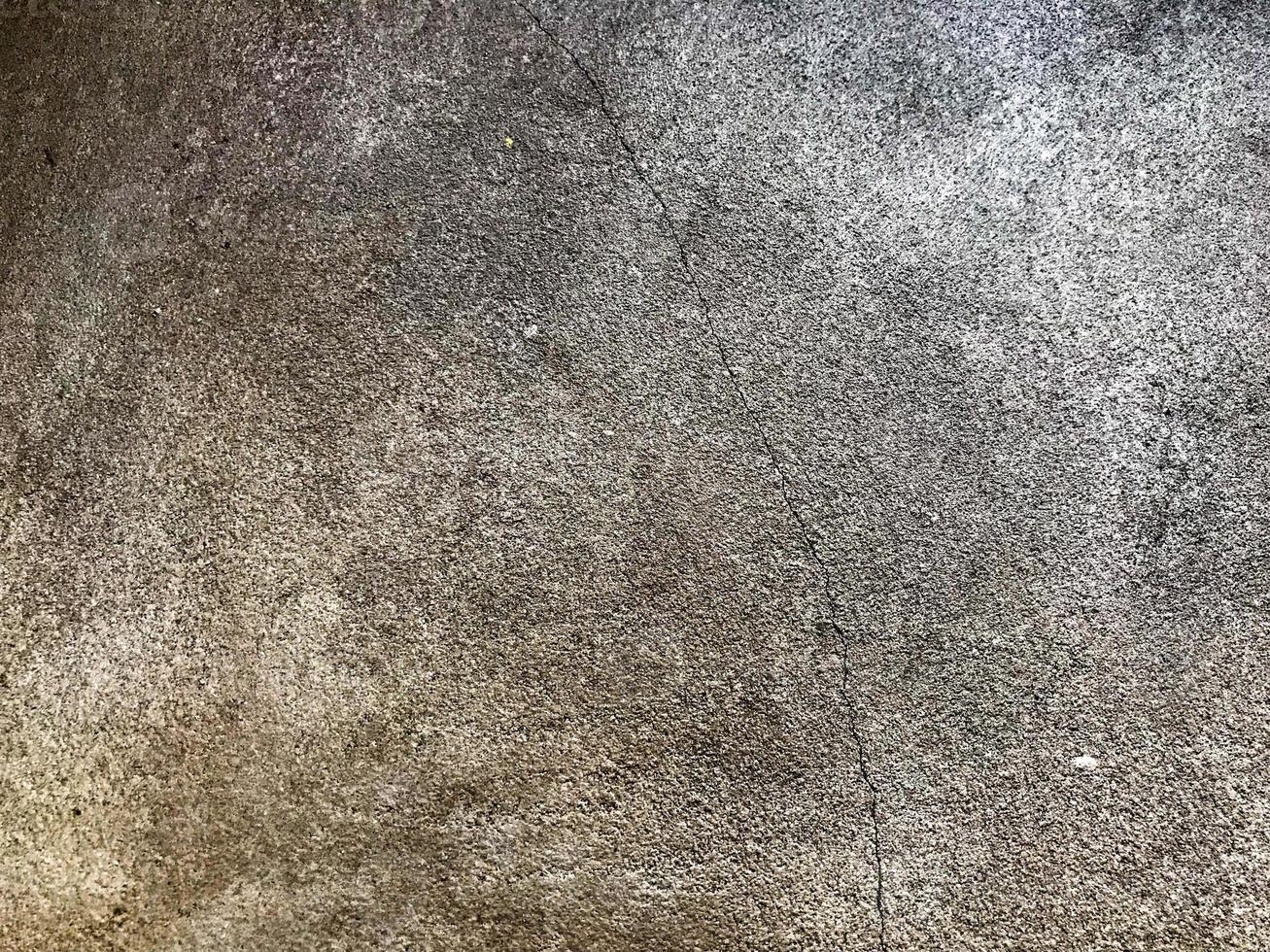 a textura do cimento concreto gasto áspero resistente cinza. o fundo foto