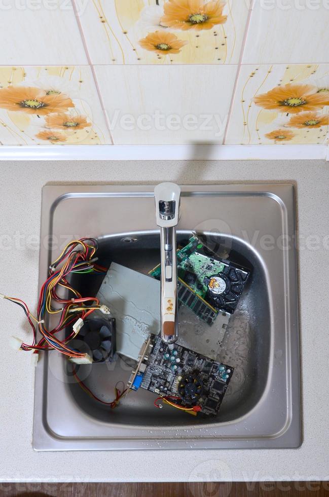 hardware na pia da cozinha sob o conceito metafórico de limpeza de computador de fluxo de água foto