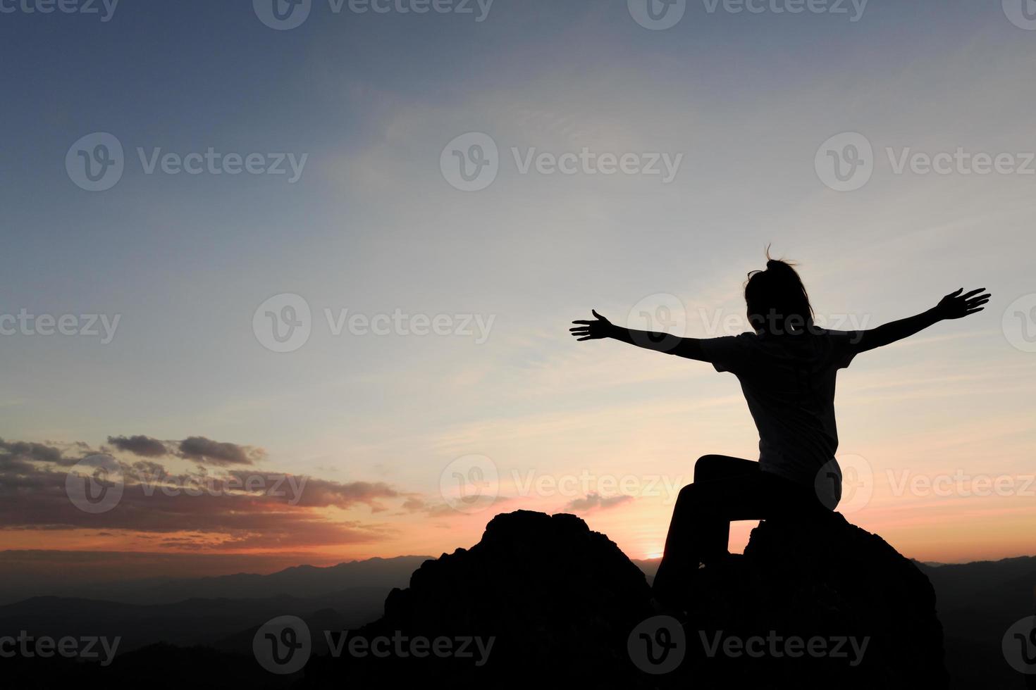 mulher rezando nas montanhas do pôr do sol, conceito férias harmonia ao ar livre com a paisagem da natureza, viagem estilo de vida espiritual relaxamento emocional meditando. foto