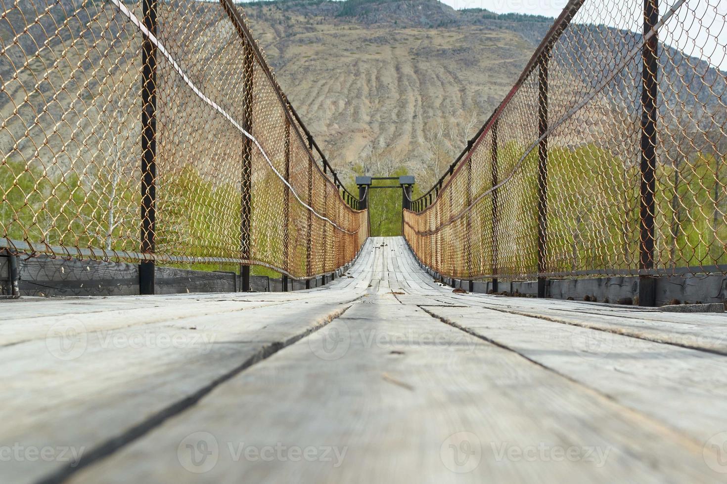 ponte suspensa sobre o rio de montanha chulshman, república de altai. viajar pela rússia. foto