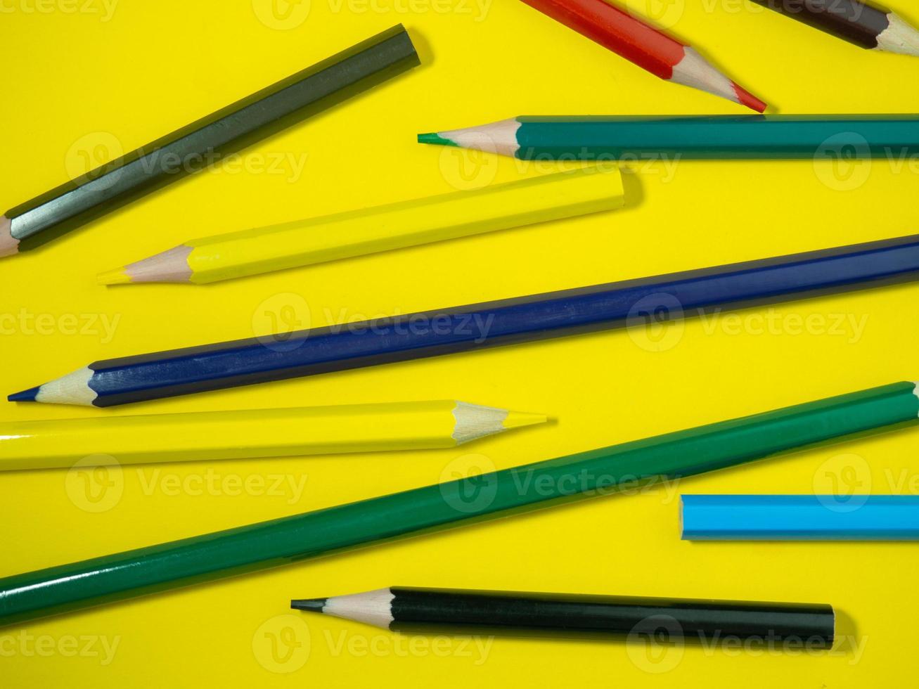lápis de madeira de cor sobre papel colorido. lápis apontados. ferramenta de desenho. acessórios para a criatividade. foto