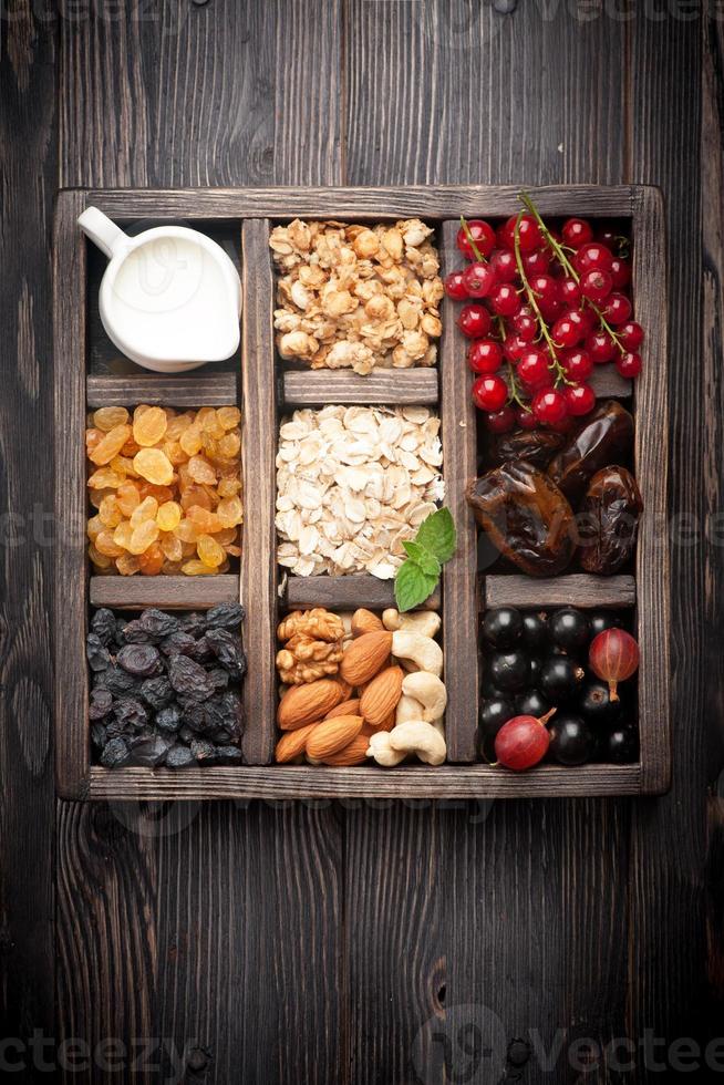 granola, frutas vermelhas, nozes, frutas secas e leite. vista do topo. horizontal foto
