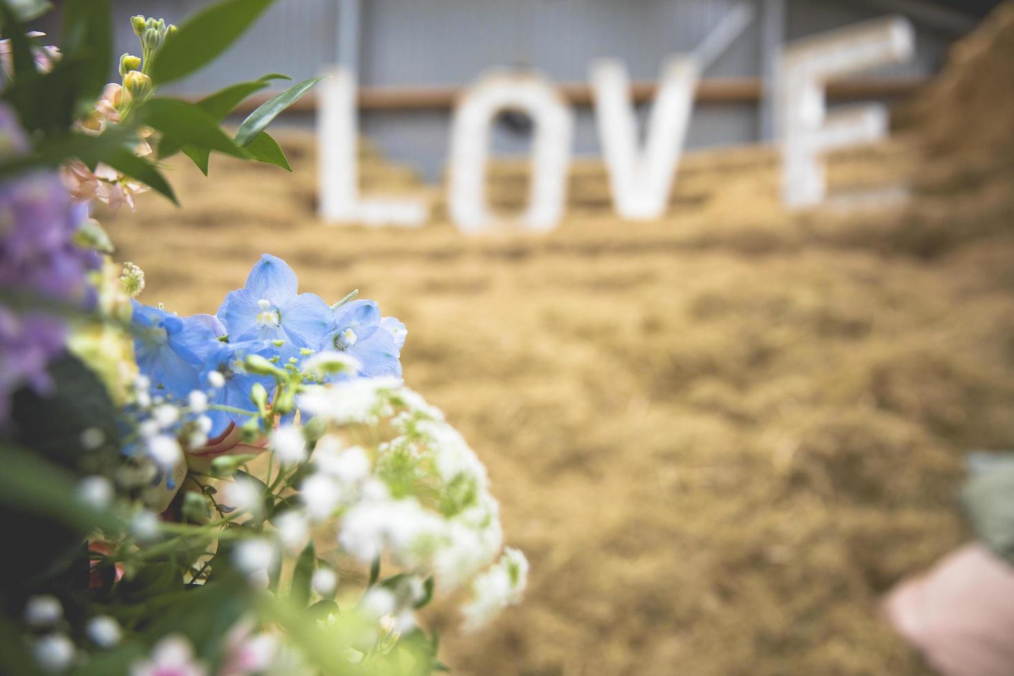 bouquet de flores em tons pastel com letras de amor ao fundo foto