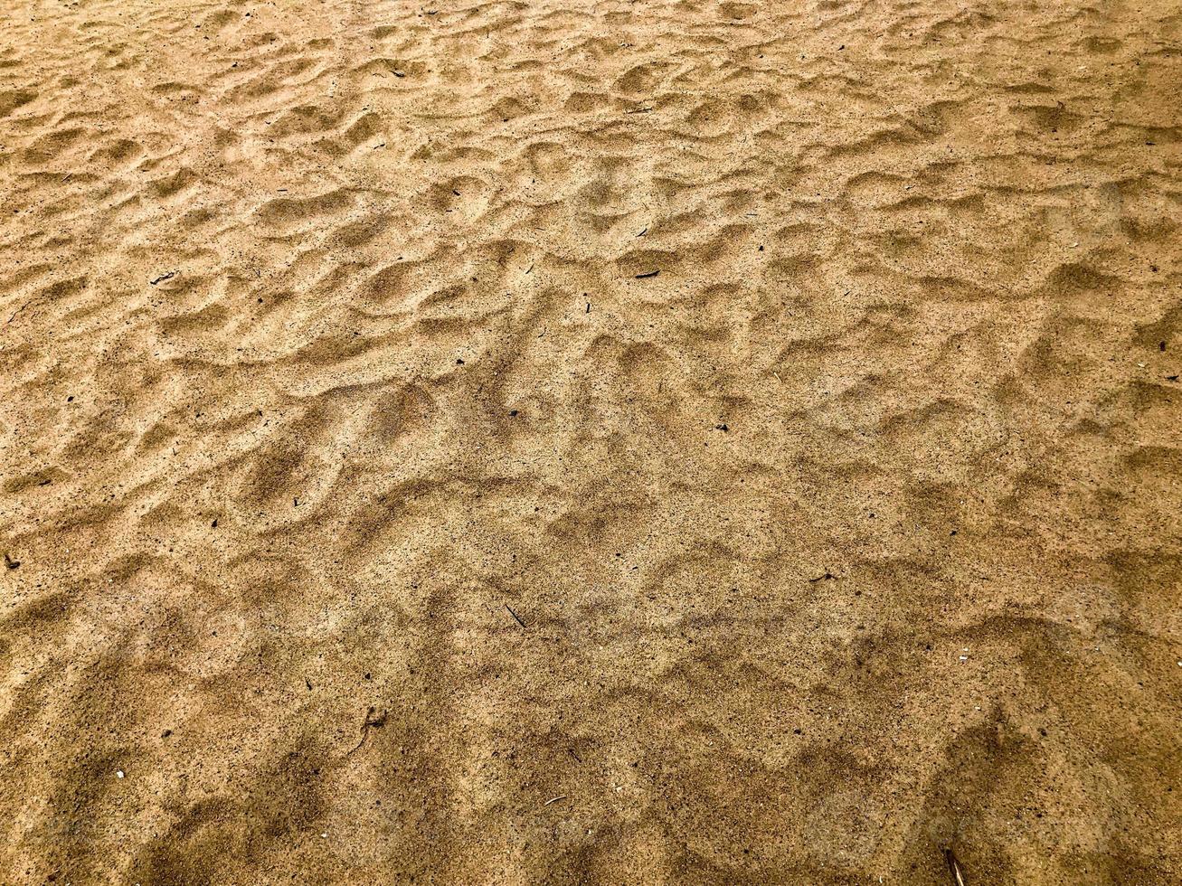 textura de areia de praia quente linda amarela solta natural. o fundo foto