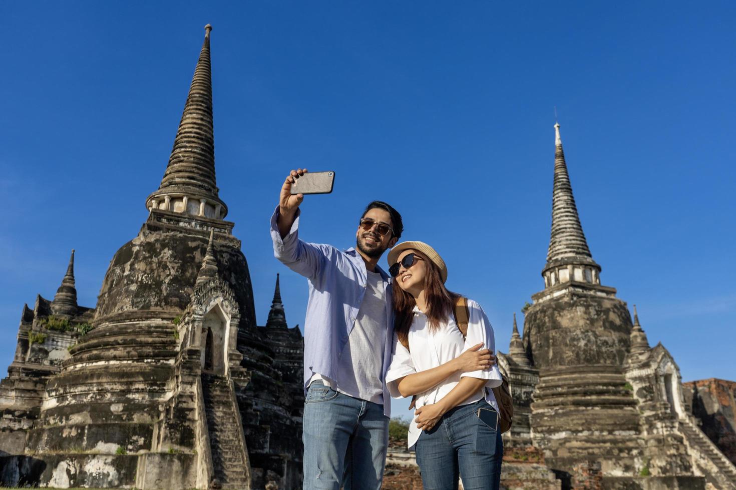 casal de turistas estrangeiros tira foto de selfie no templo wat phra si sanphet, ayutthaya tailândia, para viagens, férias, férias, lua de mel e conceito de turismo
