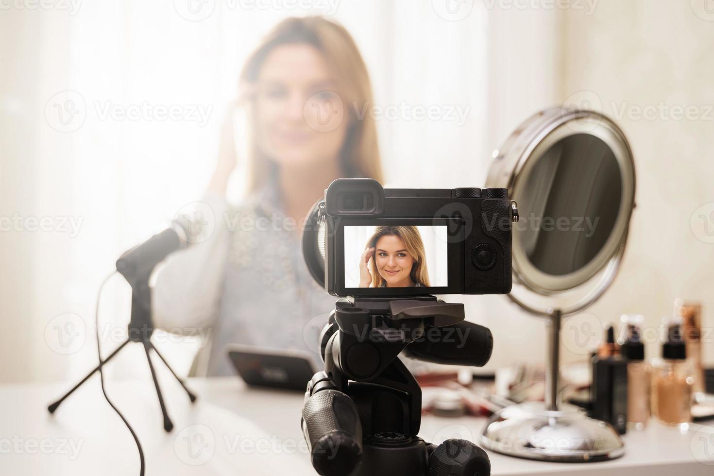 câmera sem espelho moderna gravando vídeo da rotina de maquiagem do blogueiro de beleza foto