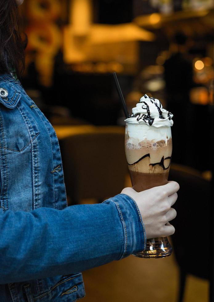 mulher segurando coquetel com leite de chocolate frio foto