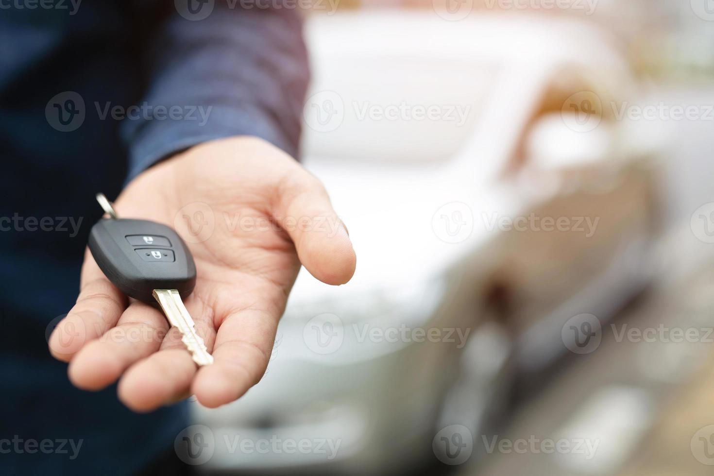 chave do carro, empresário entregando dá a chave do carro para o outro homem no fundo do carro. foto