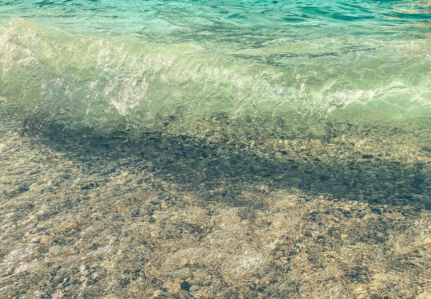 água azul com espuma borbulhante, costa do mar para os turistas relaxarem no resort. ondas do mar turquesa, paisagem, textura da água foto