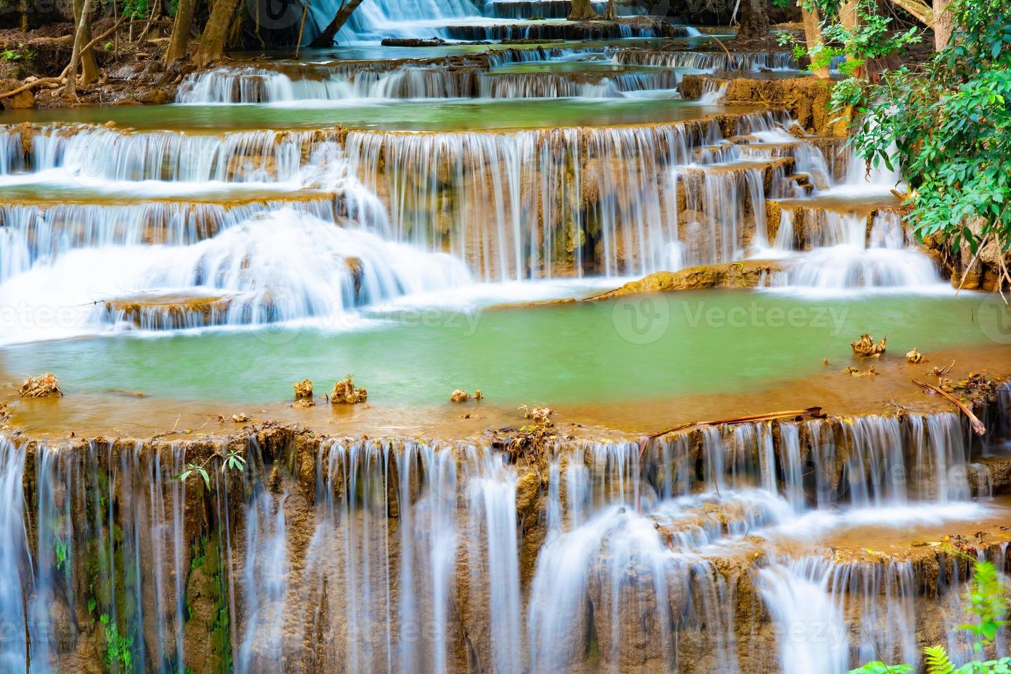 incrível cachoeira colorida na floresta do parque nacional durante a primavera, bela floresta profunda na tailândia, longa exposição técnica, durante as férias e relaxar. foto