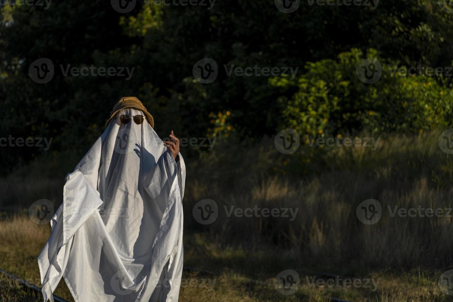 fantasma branco de olhos negros, feito de lençol. chapéu branco foto