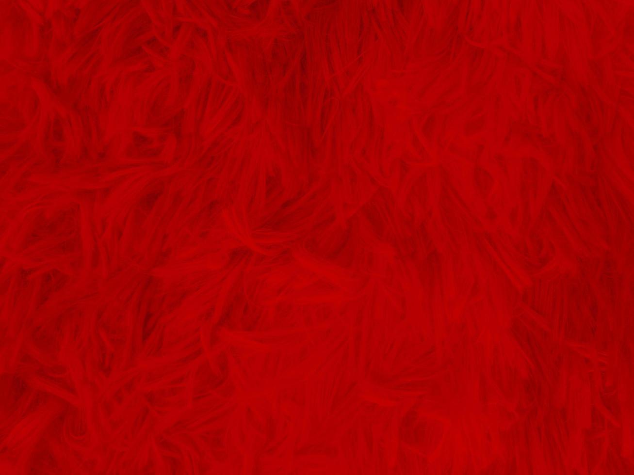 fundo de textura de lã limpa vermelha. lã de ovelha natural leve. algodão sem costura vermelho. textura de pele fofa para designers dia de natal. tapete de lã vermelho fragmento de close-up.. foto