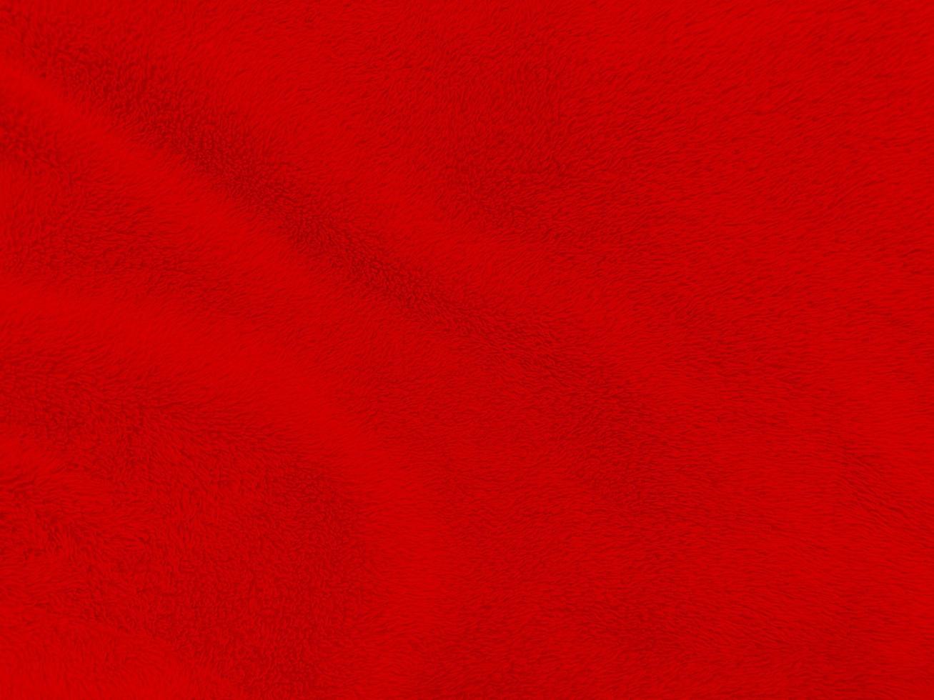 fundo de textura de lã limpa vermelha. lã de ovelha natural leve. algodão sem costura vermelho. textura de pele fofa para designers dia de natal. tapete de lã vermelho fragmento de close-up.. foto