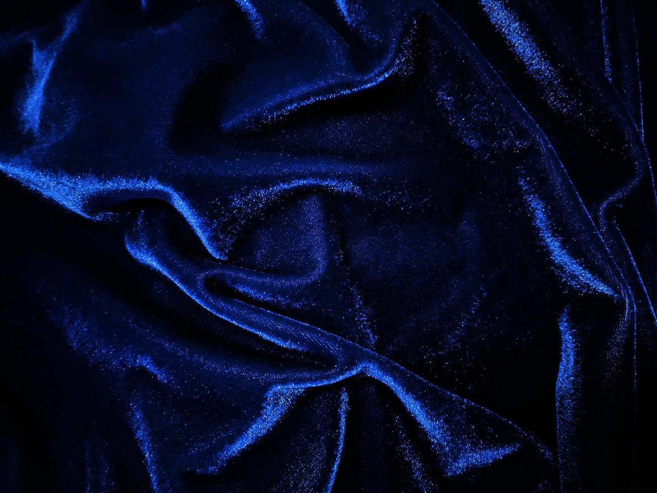 textura de tecido de veludo azul usada como pano de fundo. fundo de tecido azul vazio de material têxtil macio e suave. há espaço para texto. foto