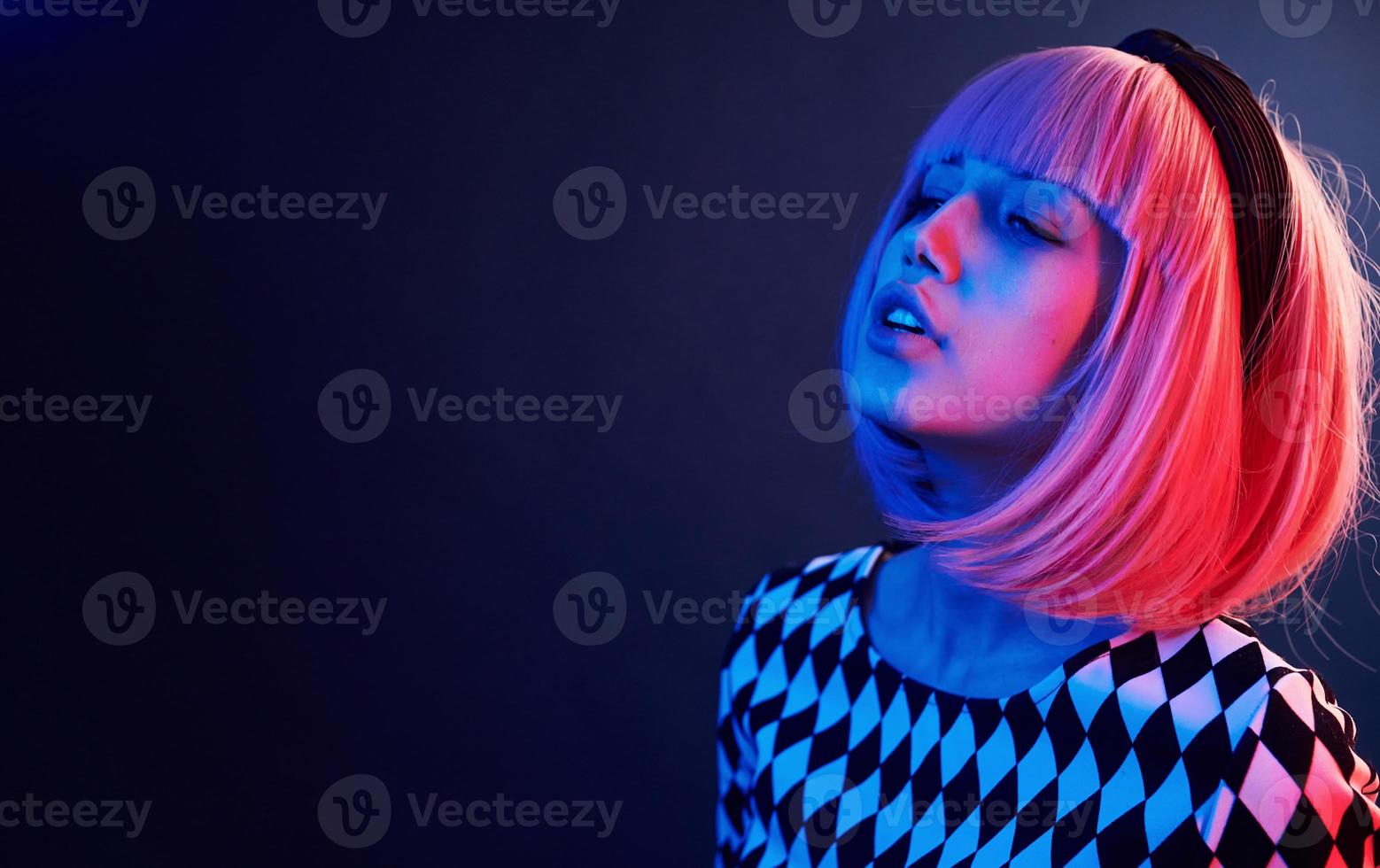 retrato de jovem com cabelo loiro em néon vermelho e azul no estúdio foto