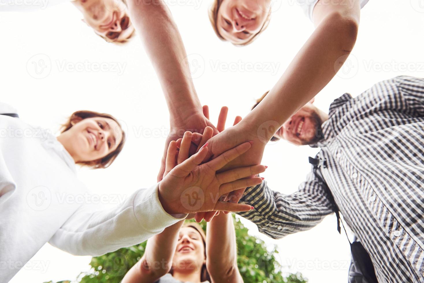 close-up vista das mãos da jovem equipe de amigos bem sucedidos ao ar livre foto