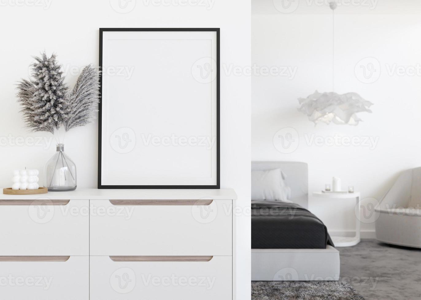 Moldura para retrato vertical vazia na parede branca no quarto moderno. mock up interior em estilo contemporâneo. livre, copie o espaço para sua foto. cama, aparador, capim dos pampas em vaso. renderização 3D. foto