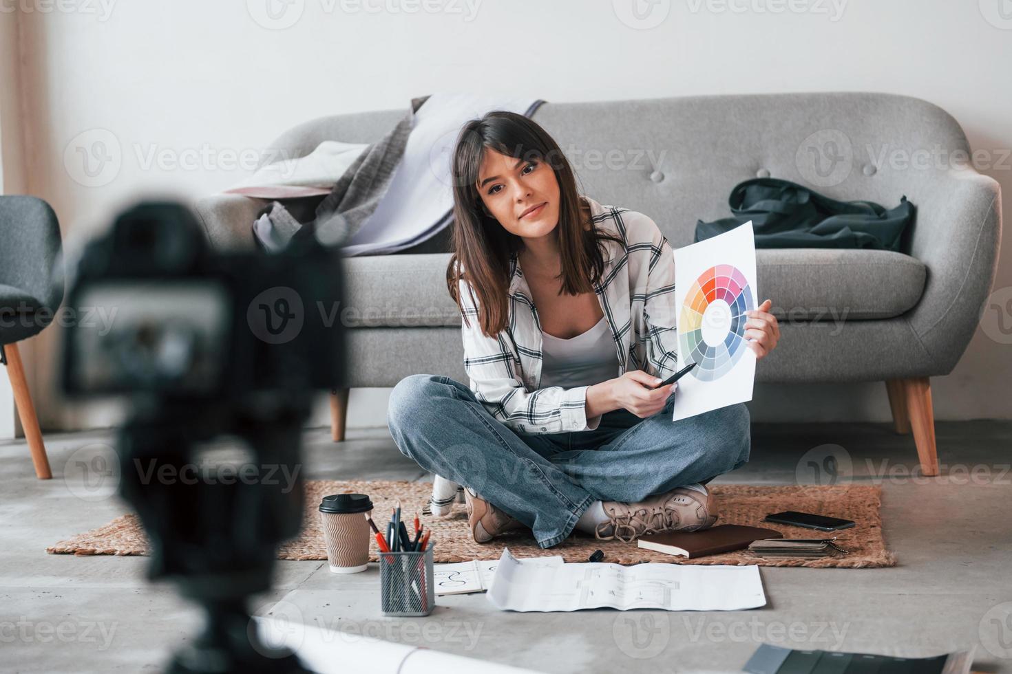 câmera está no chão. jovem trabalhadora freelance está dentro de casa durante o dia foto