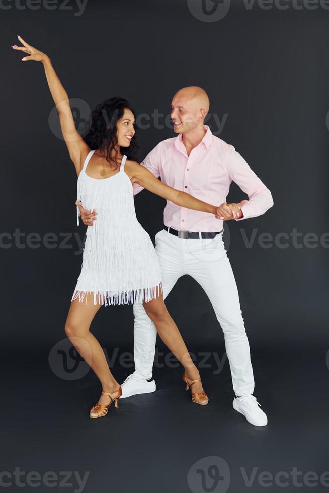 dançando no estúdio. casal alegre está junto dentro de casa foto