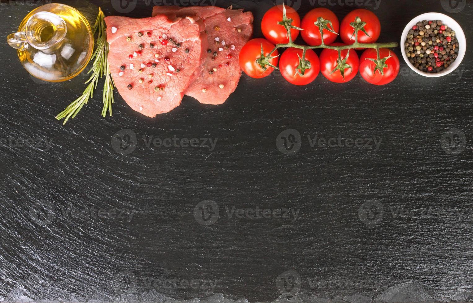 bife cru com especiarias e ingredientes para cozinhar. postura plana. vista do topo. foto