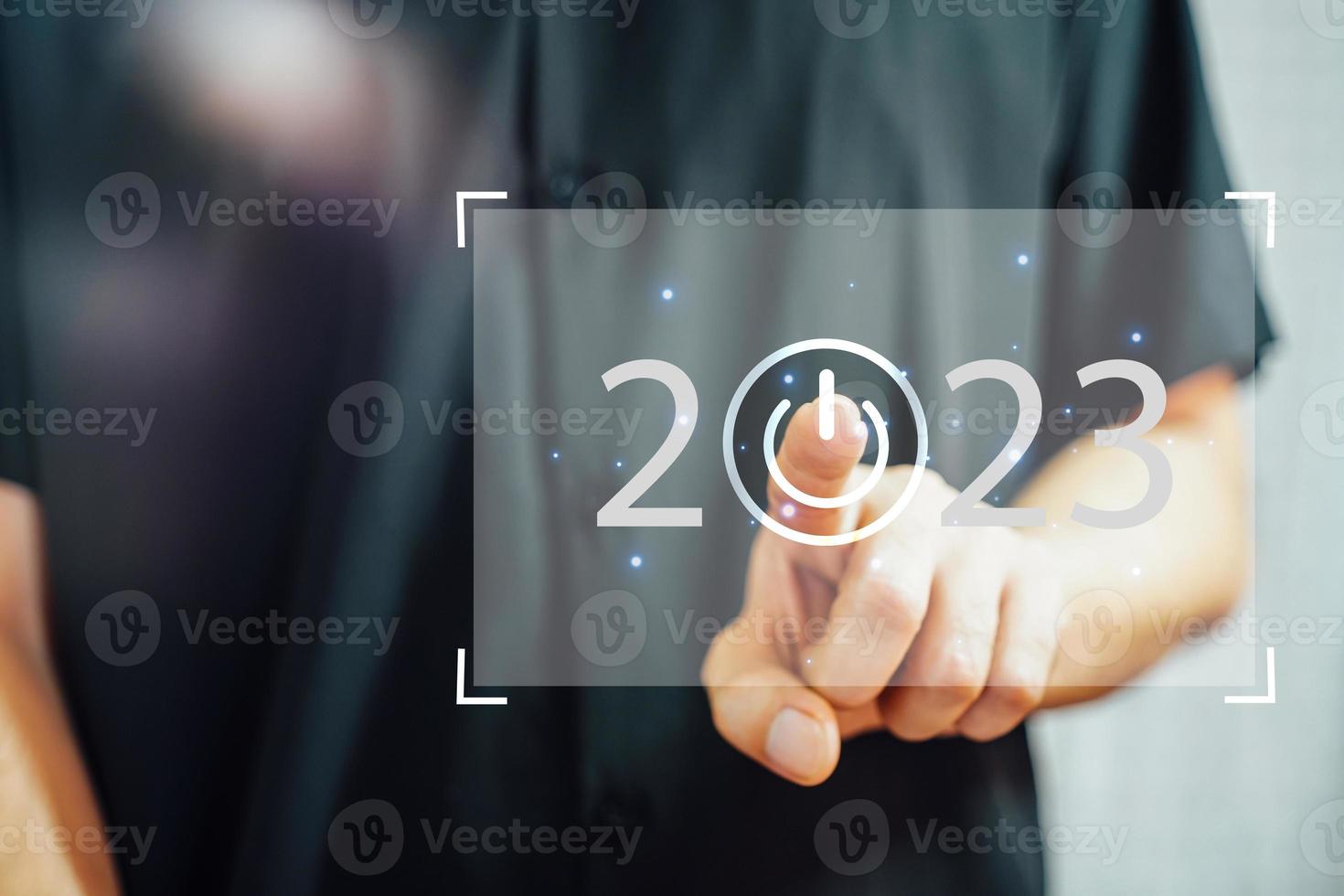 bem-vindo ano de 2023. ano novo 2022 mudança para o conceito de 2023, mão de empresário tocando na tela virtual de 2023. foto